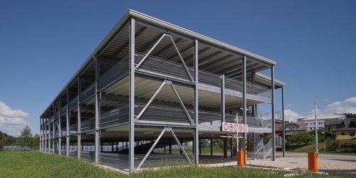 Steel multi-storey car park with green grass in the foreground