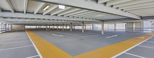 Interior or parking garage with yellow pedestrian path