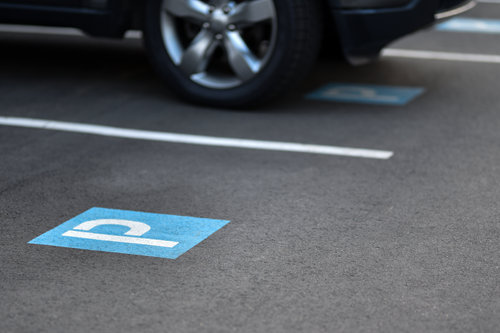 Parking bay displaying a blue P icon, parked car in background